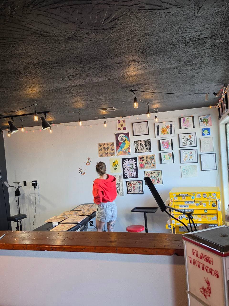 Kyla browsing the flash art wall at The Painted Lady